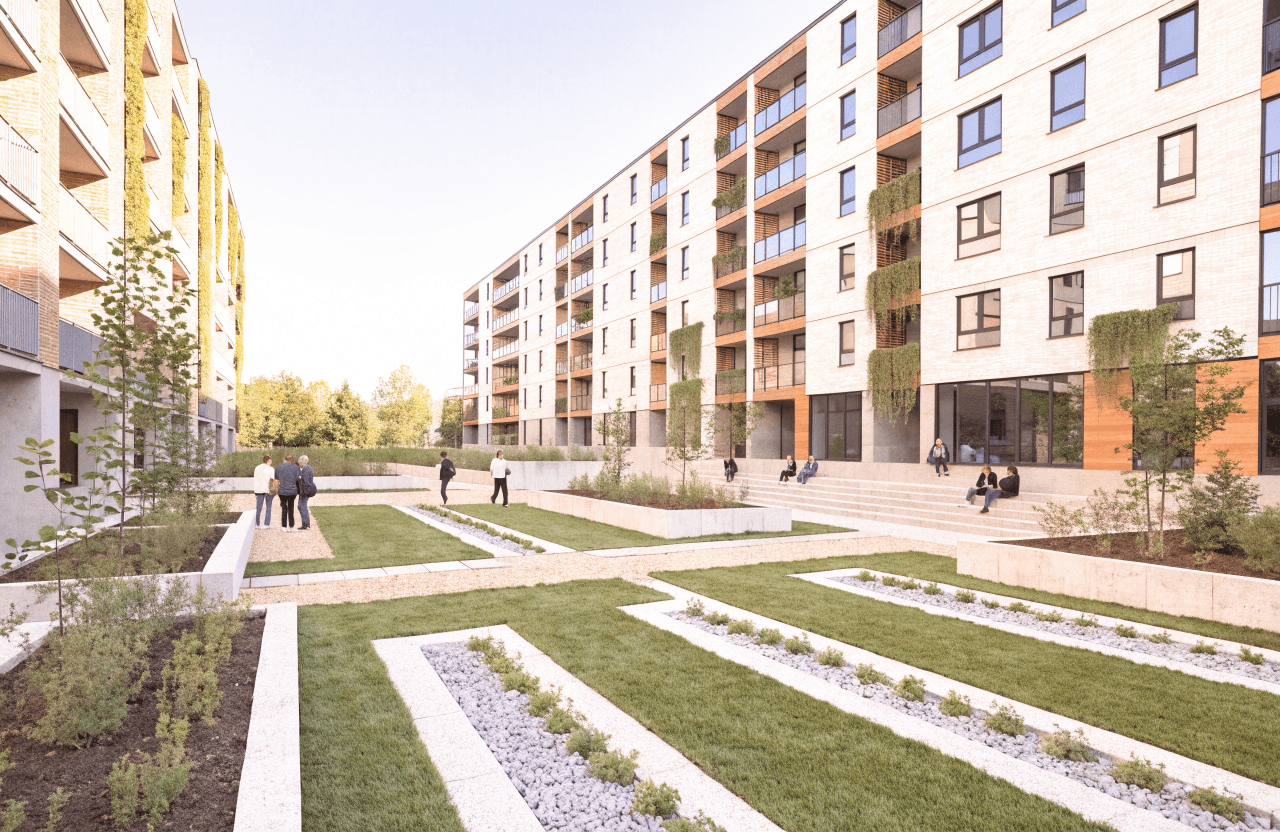 A pedestrianized residential courtyard plaza surrounded by retrofitted apartment buildings, where neighbours gather among communal planters, seating areas, and permeable green paving.